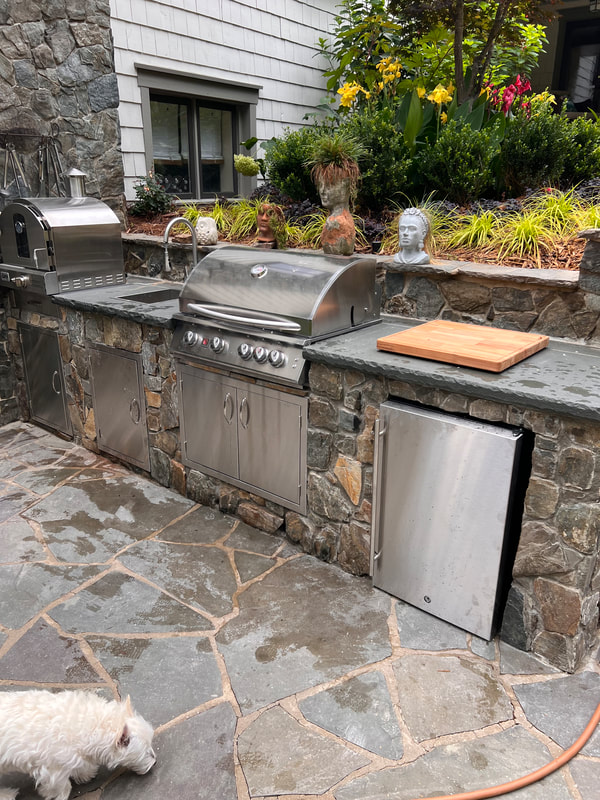 Outdoor kitchen with natural stone counter in Charlotte, NC.